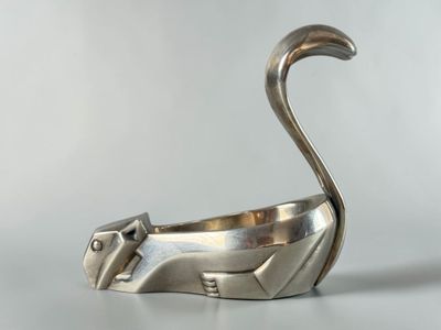 an image of a silver cat figurine sitting on a table