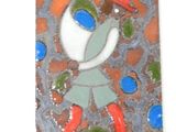 a small tile with a picture of a girl on it