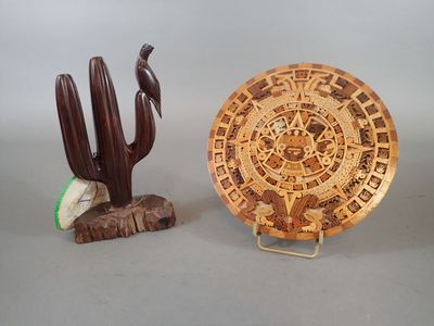a wooden plate and a wooden cactus on a table