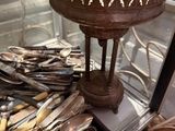 a display case filled with silverware and silverware