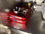 a red basket that is sitting on a metal counter