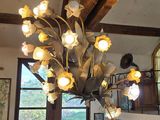 a chandelier that has a bunch of flowers hanging from it