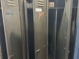 several metal lockers are lined up in a row in a room