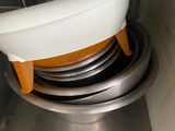 a white bowl sitting on top of a stack of plates