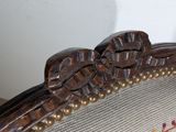 a close up of a chair with a decorative design on it