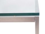 a glass table with a metal base and a glass top