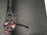 a close up of a pair of scissors on top of a piece of black paper
