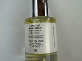 a bottle of body oil sitting on top of a white table