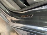 a close up of a car door handle with a sticker on it