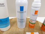 many different types of skin care products on a wooden tray