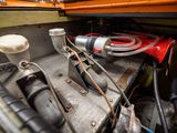 a close up of a car engine with a hose attached to it
