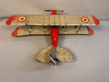 a toy airplane that is sitting on a white surface