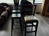 several chairs and a table in a living room with a couch