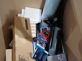a cardboard box full of assorted items in it
