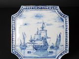 an old blue and white plate with a ship on it
