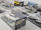 many different models of cars on display in a display case
