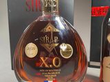 a bottle of brandy next to a box of wine