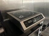 a stove with a burner on top of it in a kitchen