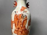 a vase with a picture of a man and a woman on it