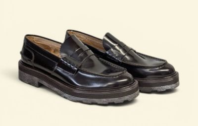 black loafer shoes with rubber soles on a white background
