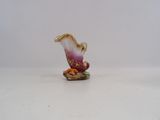 a small figurine of a flower on a white surface