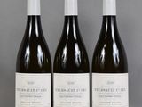 three bottles of wine sitting on top of a table next to each other