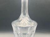 a clear glass vase on a table with a gray background