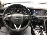 the interior of a car with a steering wheel and dashboard controls