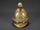 a gold helmet with a bird on the top of it
