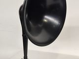 a black speaker sitting on top of a white table