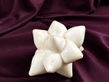 purple satin fabric with a white flower on top of it