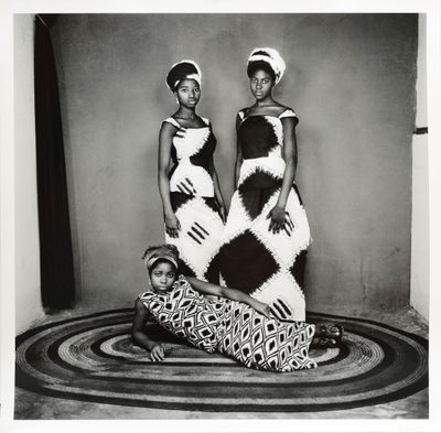 an old black and white photo of two women in dresses