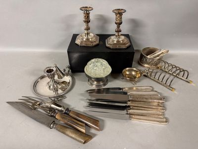 a lot of silverware on a table with a black box