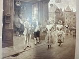 an old picture of a group of people walking down the street