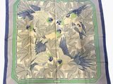 a close up of a square scarf with birds on it