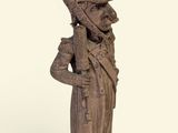 statue d'un homme portant un chapeau et tenant une canne