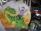 a cardboard sign with a picture of a man riding a t - rex