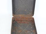 an old suitcase sitting on a white surface with a handle
