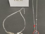 two pieces of jewelry sitting on top of a table next to a box
