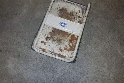 un téléphone portable sale posé par terre dans un garage