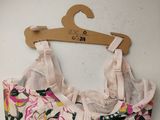 a bra top hanging on a hanger on a wall
