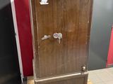 a wooden cabinet with a key on it in a room