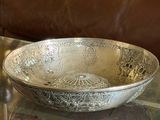 a bowl sitting on a glass table with a brown couch in the background