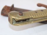 a close up of a knife on a white surface