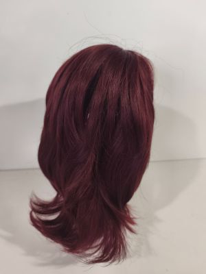 a close up of a wig on a mannequin head on a white surface