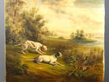 un tableau représentant deux chiens et un oiseau, posé sur un chevalet