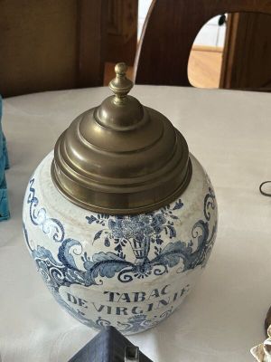a blue and white vase sitting on top of a table