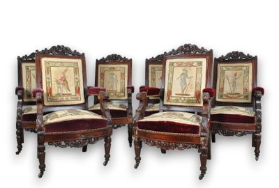 four chairs with red velvet upholstered seats and a picture on the back of them