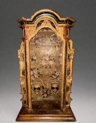 an antique wooden clock with gold and black paint on it