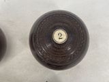 three wooden balls with numbers on them sitting on a table